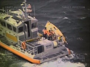 A Coast Guard 45-foot Response Boat-Medium crew from Station Port Angeles, Wash., rescues a man after his sailboat overturned near Port Townsend - (U.S. Coast Guard picture by Petty Officer 3rd Class Sean Farrar)